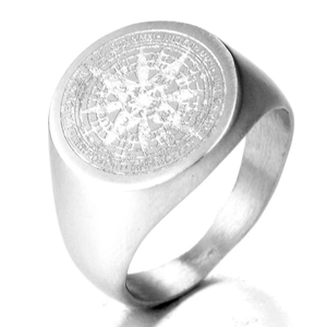Macro shot of silver stainless steel signet ring with engraved compass and star motif