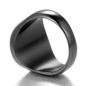 Macro view of black stainless steel compass ring with matte finish and polished inner band