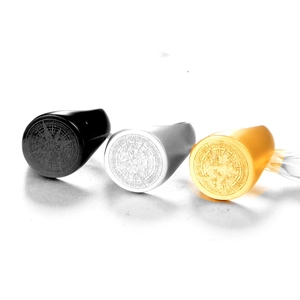 Detailed view of men's stainless steel compass signet rings in black, silver, and gold