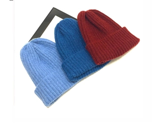 Detailed ribbed knit texture on beanies in light blue, dark blue and burgundy colors
