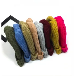 Flat lay of colorful ribbed knit beanies in eight vibrant shades on white background