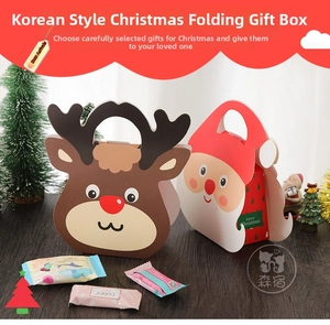 Close-up of Santa Claus and Reindeer themed Christmas gift bags with carry handles