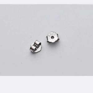 Pair of S925 sterling silver butterfly earring backs showing the metal hallmark stamp