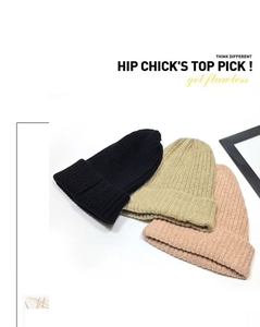 Detailed close-up of knitted beanies in black, beige, and pink with soft textures