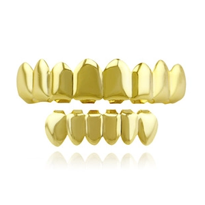 Macro detail of 18K gold-plated hip-hop grillz set showing polished mirror finish texture