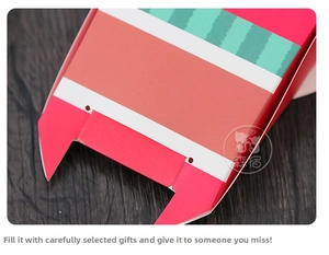 Close-up detail of a watermelon-themed Christmas treat box made of thick paperboard
