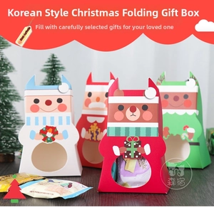 Detail of Christmas gift boxes with Santa, reindeer, and snowman window designs