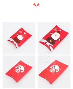 Detailed view of red pillow-shaped Christmas gift boxes with Santa and reindeer patterns