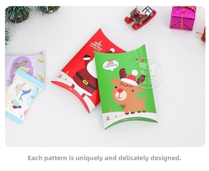 Detail of red Santa and green reindeer Christmas pillow boxes with festive decorations