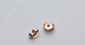 Macro shot of rose gold plated S925 sterling silver earring backs with hallmarks