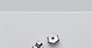 Macro shot of S925 sterling silver earring backs showing authentic hallmark detail