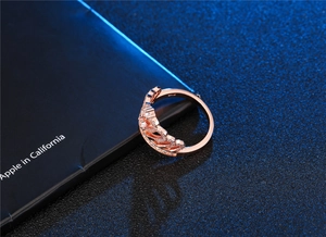 Detailed macro view of a rose gold crown ring featuring micro-pave cubic zirconia crystals