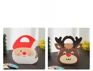 Detail view of Santa Claus and Reindeer paper gift bags with handles on wooden table