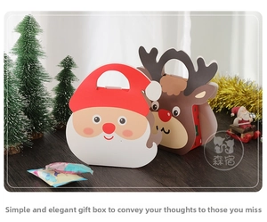 Close-up of Santa Claus and reindeer Christmas gift boxes with portable handles