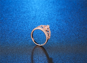 Macro close-up showing crown ring detail with rose gold plating and micro-pave crystals