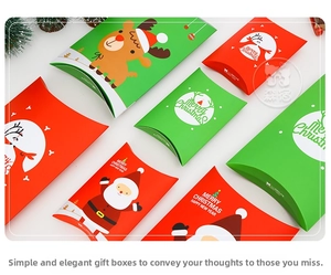 Detail of Christmas pillow gift boxes in red and green with Santa and reindeer prints