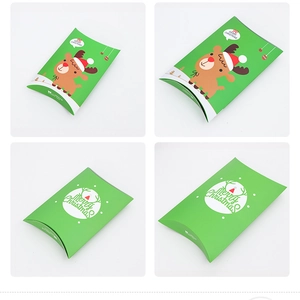 Detailed views of green reindeer pillow gift boxes with Merry Christmas holiday printing