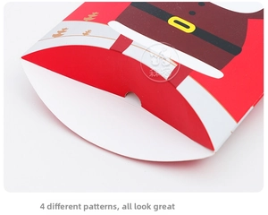 Macro view of Santa-themed pillow gift box with iconic red suit and belt design details