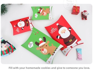 Detailed macro view of festive red Santa and green reindeer pillow candy gift boxes