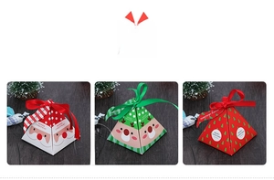 Detailed view of pyramid-shaped Christmas gift boxes in red, green and white with ribbons