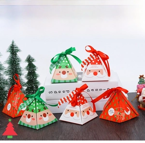 Detail of pyramid-shaped Christmas gift boxes with festive reindeer and Santa patterns