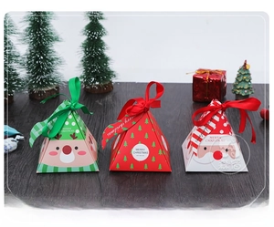 Detailed view of pyramid-shaped Christmas gift boxes with festive patterns and ribbon closure