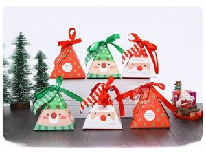 Detail of pyramid Christmas gift boxes in red, green, and white with ribbon bows