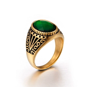 Men's vintage gold titanium ring featuring a large oval green faceted gemstone inlay