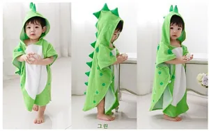 Detailed close-up of green dinosaur hooded cotton poncho towel for toddlers