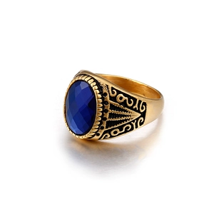 Men's vintage gold ring with oval faceted blue gemstone and ornate scroll engravings