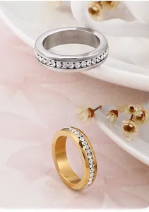 Detailed macro view of 18K gold and silver plated titanium rings with full cubic zirconia