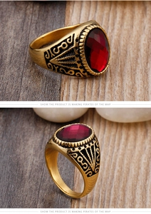 Detailed macro of vintage men's gold ring with red oval gemstone and antique engravings