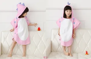 Detail of pink cotton dinosaur hooded towel with blue 3D back scales for children