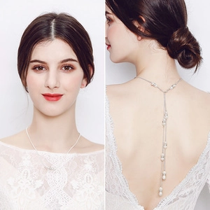 Detailed view of elegant back-drop pearl necklace with long tassels for backless dresses