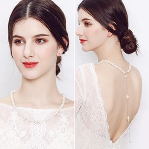 Detail of white pearl bridal back necklace showing front view and elegant back drape