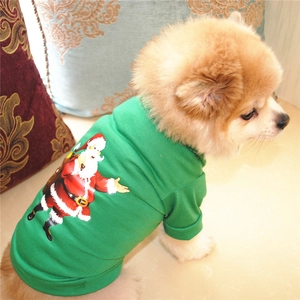 Close-up of a green Christmas dog T-shirt with Santa print on a small Pomeranian