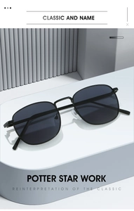 Minimalist rectangular sunglasses with black lenses and slim metal temples on a white stand
