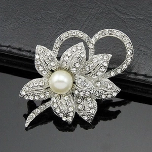 Elegant floral pearl brooch with sparkling rhinestones in a silver setting for outfits