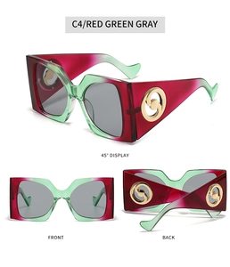 Detail view of square sunglasses with red-green gradient frames and gold metal logo