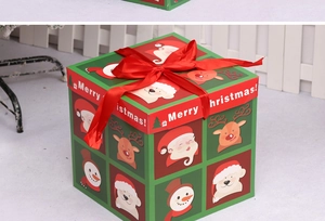 Close-up of a Christmas gift box featuring cartoon characters and a red satin ribbon bow