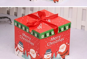 Close-up of red Christmas gift box with festive Santa Claus prints and red satin ribbon bow