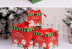 Three-size nested Christmas gift boxes in red and green with festive ribbons and illustrations