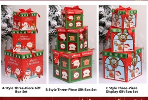Three-piece nesting Christmas gift boxes with festive reindeer and Santa patterns
