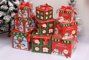 Detail of stacked red and green Christmas gift boxes with Merry Christmas motifs