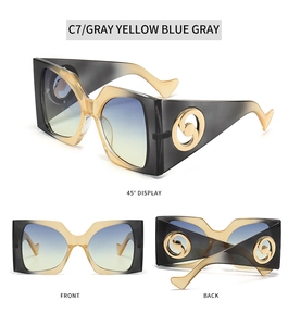 Detailed view of oversized square sunglasses featuring a black to yellow gradient frame