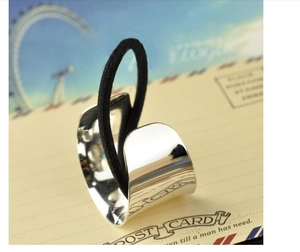 Polished silver metal ponytail cuff with black elastic tie shown on a postcard