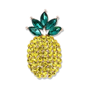 Macro detail of pineapple brooch with yellow round crystals and green marquise gems