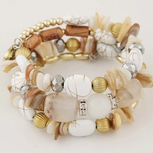 Macro detail of Bohemian beaded bracelet featuring wood beads and crystal charms