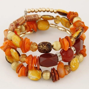 Detail of bohemian layered wrap bracelet with orange shells and beaded crystal accents