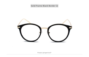 Close-up of retro round glasses frame in black and gold metal with clear lenses